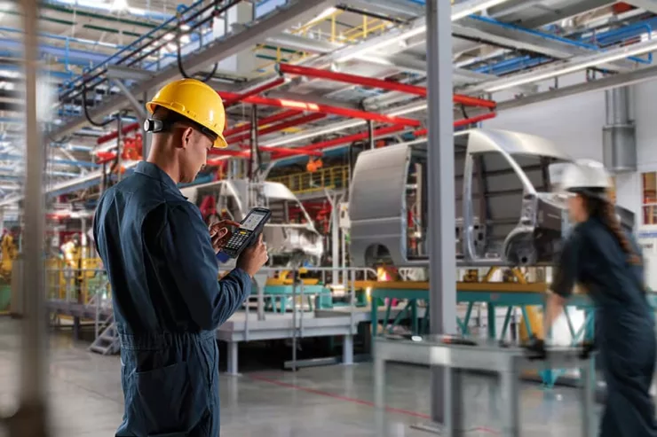 A worker using voice recognition technology in automotive manufacturing