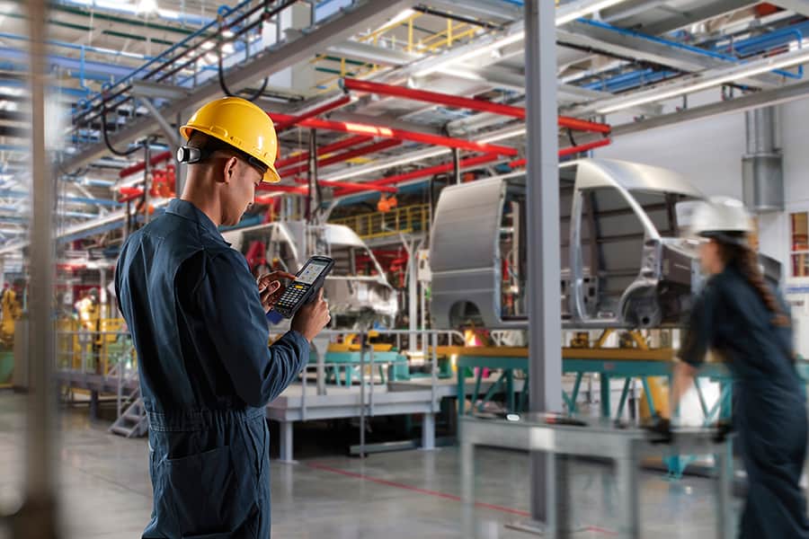 A worker using voice recognition technology in automotive manufacturing