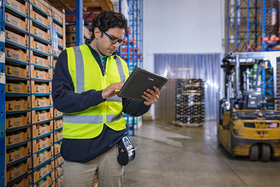 Warehouse employee using voice picking technology to ensure supply chain excellence